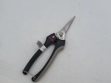 a pair of scissors on a white surface next to a toothbrush