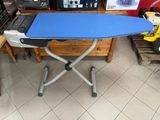 a blue ironing board sitting on top of an ironing board