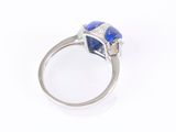 a close up of a diamond and lapis ring on a white background