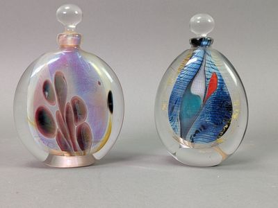 two glass perfume bottles with different designs on them