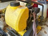 a yellow tank with a hose attached to it