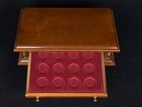 an image of a small wooden box with a red cover