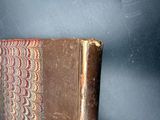 an old book sitting on top of a wooden table