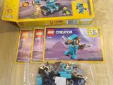 two boxes of lego creator figures sitting on a wooden table
