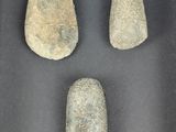 three rocks in a shadow box on display in a museum