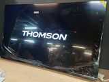 a television sitting on a table with a remote in front of it