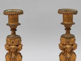 pair of antique brass candlesticks with ornate designs on bases