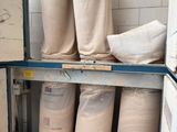 many bags of sand sitting on a shelf in a room