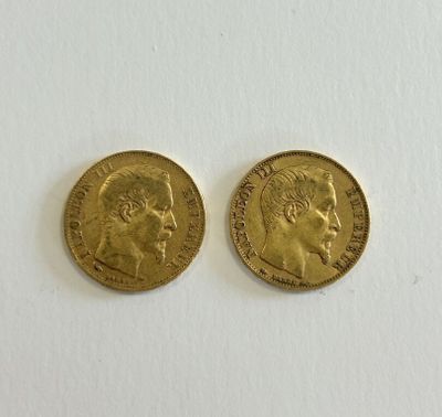 two gold sovereigns, one with the head of a man and the other of a woman