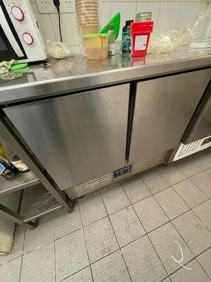 a stainless steel counter with a bunch of items on top of it