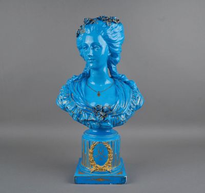 a blue busturine of a woman with a wreath on her head