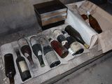 many bottles of wine sitting in a box on the floor