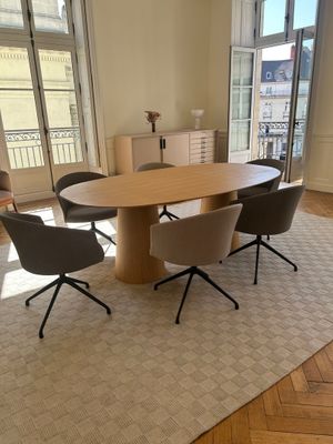a table and chairs in a room with a large window