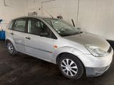 a silver car that is parked in a garage