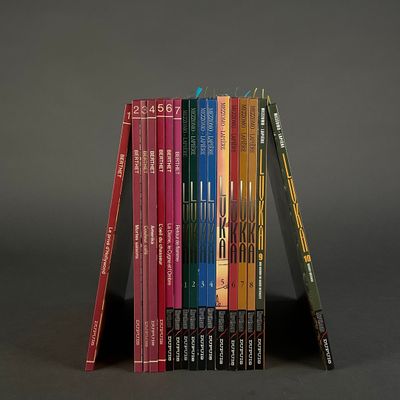 books stacked on top of each other on a black surface