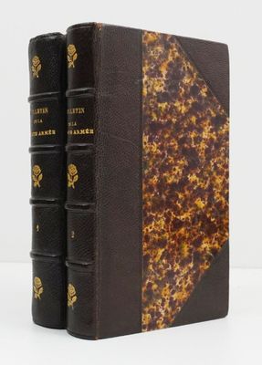 two books sitting on top of each other on a white surface