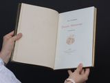 a person holding an open book in their hands