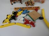 a pile of wooden toys on a white table