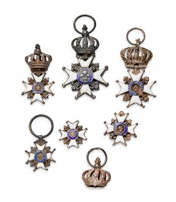 a group of six silver and gold medals and a cross
