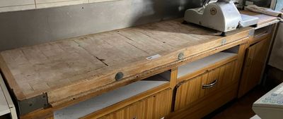 a wooden counter with a machine on it in a kitchen