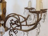 a chandelier that has a candle holder and some crystal beads hanging from it