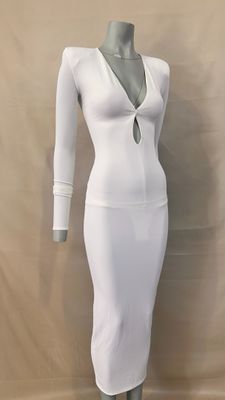 the dress is white and has long sleeves and a deep v - neck