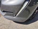 a close up of the front of a car with a dent in it