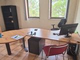 une pièce équipée d'une table, de chaises et d'un réfrigérateur