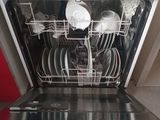 a dishwasher that is open in a kitchen