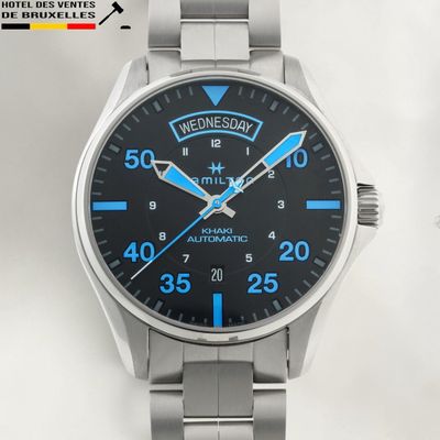 a close up of a wrist watch on a white surface
