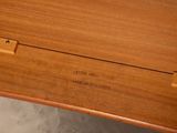 a close up of a wooden table with a name on it