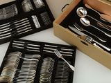 a lot of silverware in a box on the table
