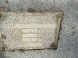 a plaque on the side of a cement building