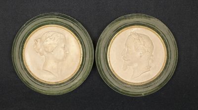 two small glass plates with two heads of a man and a woman
