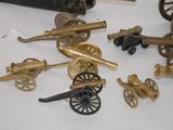 a lot of different types of toy guns on the table