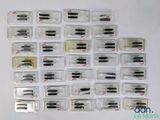 a lot of different types of sewing needles in plastic cases