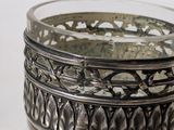 an image of a silver plate with a flower design on it