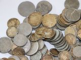 a pile of coins sitting on a white surface