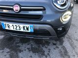 the front end of a grey fiat car parked in a parking lot