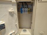 a white electrical box with wires and wires in it