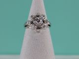 a close up of a diamond ring sitting on top of a white cone