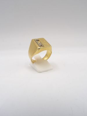 a close up of a gold ring on a white surface