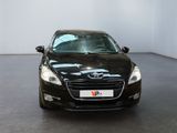 the black car is parked in a large room with a white wall