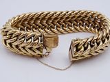 a gold bracelet with a clasp and a chain