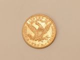 an image of a gold coin on a white surface