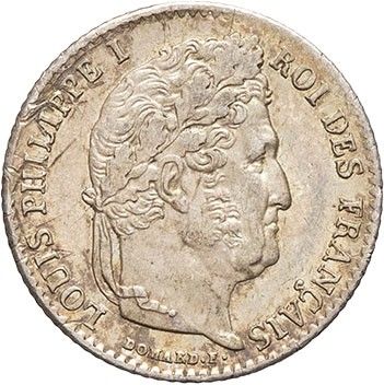 a silver coin with the head of a man in profile