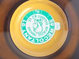a yellow frisbee with a green label on it