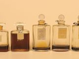 several bottles of perfume are lined up on a table