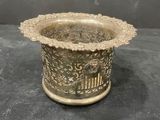 brass plated vase with a flower design on the rim