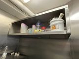 a metal shelf that has a lot of items on it